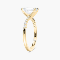 Emerald Cut Shared Prong Side Stone Engagement Ring